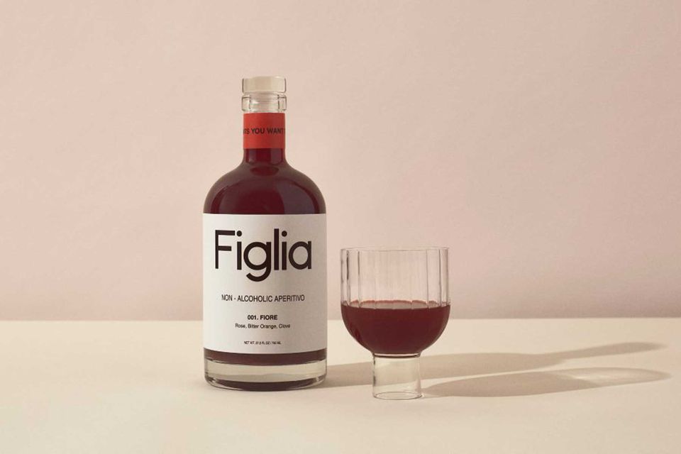 Bouteille d'apéritif sans alcool Figlia à côté d'un verre avec la boisson versée dedans